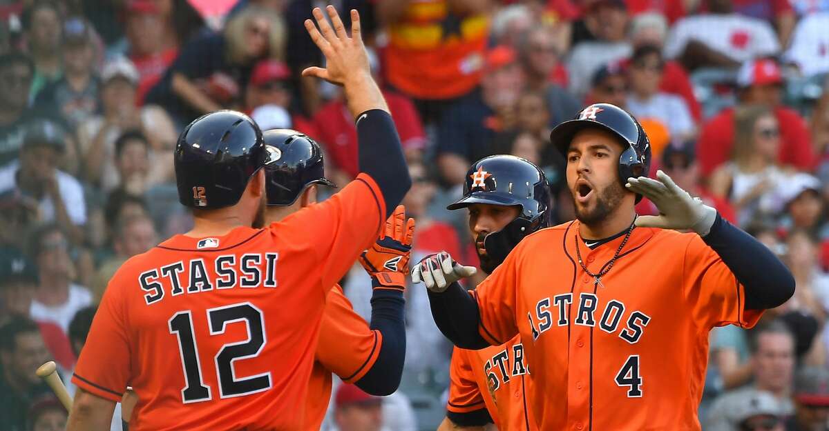 ANAHEIM, CA - JULY 21: George Springer #4 celebrates with Max Stassi #12 of the Houston Astros as he crosses the plate after hitting a grand slam home run in the sixth inning of the game off relief pitcher Taylor Cole #67 of the Los Angeles Angels of Anaheim at Angel Stadium on July 21, 2018 in Anaheim, California. (Photo by Jayne Kamin-Oncea/Getty Images)