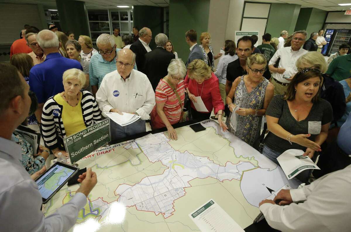 People attend the Harris County Flood Control District bond program community meeting at Kingwood Park High School, 4015 Woodland Hills Drive Kingwood, Tuesday, July 10, 2018, in Houston. ( Melissa Phillip / Houston Chronicle )