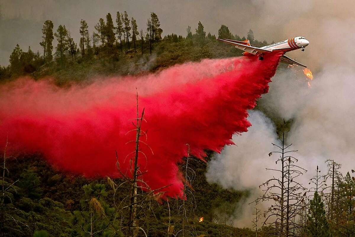 An air tanker drops retardant while battling the Ferguson fire in Stanislaus National Forest, near Yosemite National Park, California on July 21, 2018. A fire that claimed the life of one firefighter and injured two others near California's Yosemite national park has almost doubled in size in three days, authorities said Friday. The US Department of Agriculture (USDA) said the so-called Ferguson fire had spread to an area of 22,892 acres (92.6 square kilometers), and is so far only 7 percent contained. / AFP PHOTO / NOAH BERGERNOAH BERGER/AFP/Getty Images