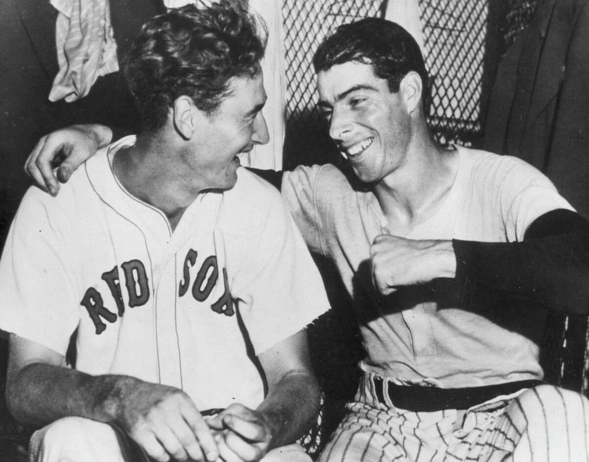 FILE - In this July 8, 1941, file photo, Joe DiMaggio, right, of the New York Yankees, congratulates Boston Red Sox slugger Ted Williams whose ninth inning homer defeated the national league All Stars, 7-5, in Detroit, Mich. A new film explores the life of baseball legend Williams who struggled with his Mexican-American heritage and his volatile relationship with his family and the press. The upcoming PBS "American Masters" documentary on the former Boston Red Sox slugger uses rare footage and family interviews to paint a picture of a complicated figure that hid his past but later spoke out and defended black players. (AP Photo/File)
