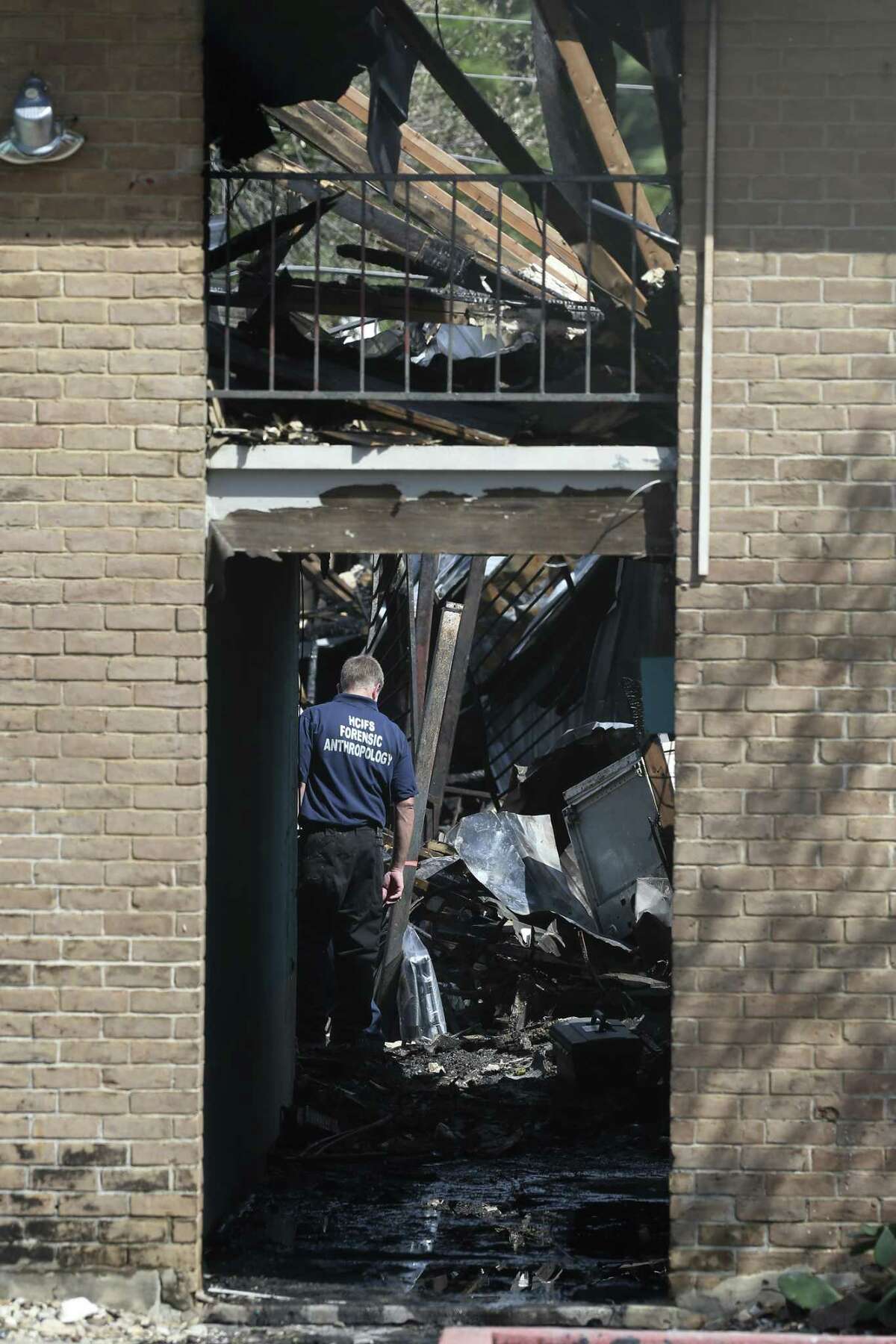 Emergency personnel investigate the scene of a fire at the Iconic Village Apartments in San Marcos, Texas, Sunday, July 22, 2018. Emergency personnel have recovered three bodies and two remain unaccounted. The fire started at 4:30 a.m. and affected about 200 residents.