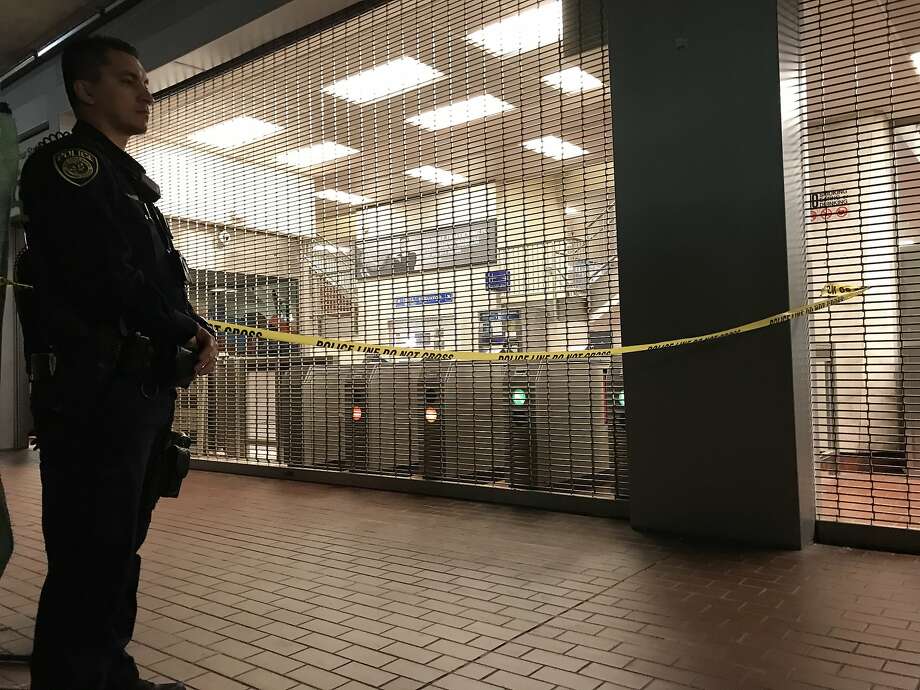   A police officer stands in front of the MacArthur BART Station closed in Oakland after a homicide on Sunday, July 22, 2018. Photo: Megan Cassidy 