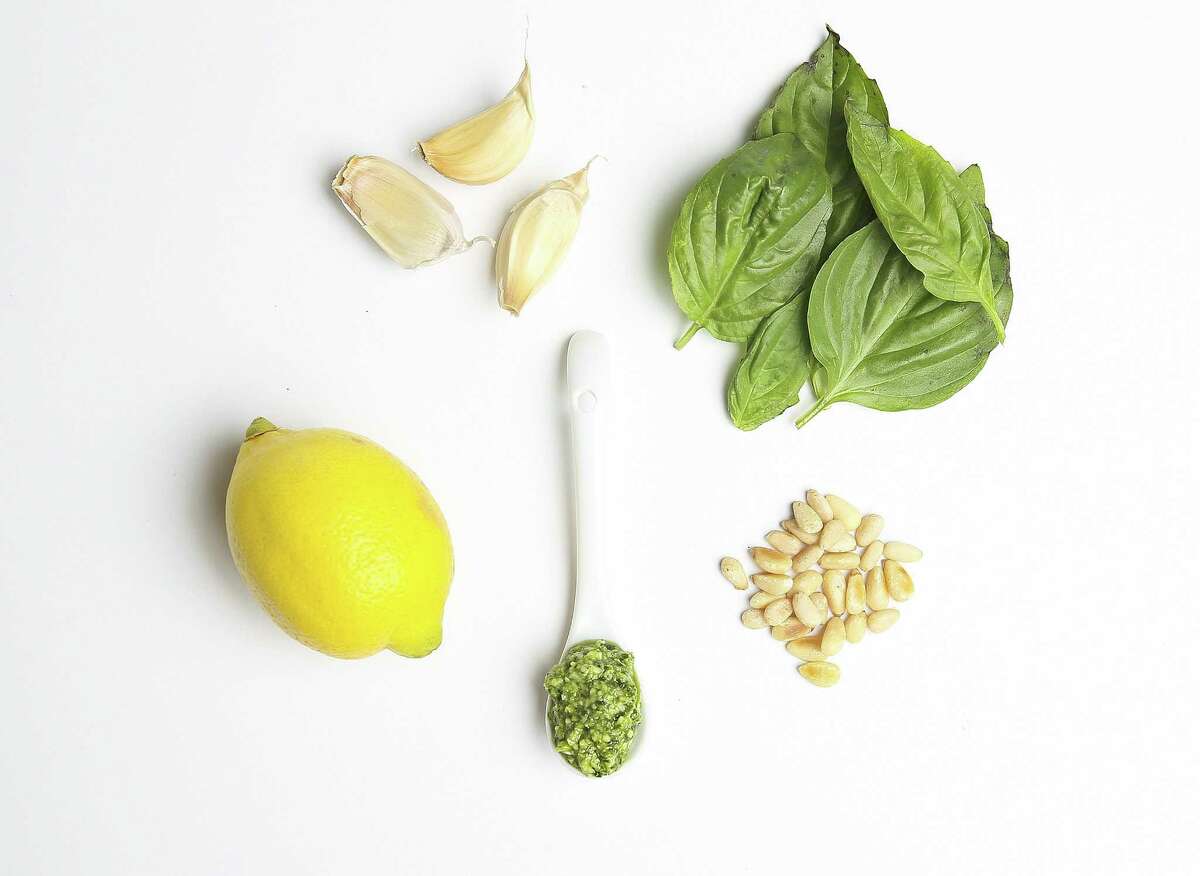 Ingredients for pesto includes garlic, basil, pine nuts and lemon.