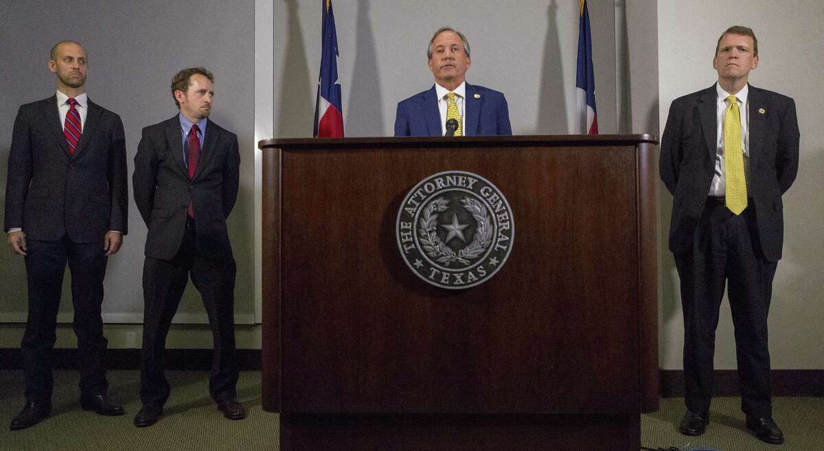 Texas Attorney General Ken Paxton announces his lawsuit against the federal government to end the Deferred Action for Childhood Arrivals (DACA) at his office in May. A coalition of businesses say the lawsuit would cause great harm to the state and national economy.