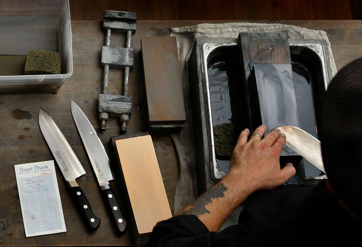 Cutler Josh Donald sharpens knives at Bernal Cutlery in San Francisco, Calif., on Tuesday, September 23, 2014.