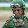 Jockey Johnny Velazquez smiles even though he wears a good portion of the muddy track after the 6th race on the card at the Saratoga Race Course Monday July 23, 2018 in Saratoga Springs, N.Y. (Skip Dickstein/Times Union)