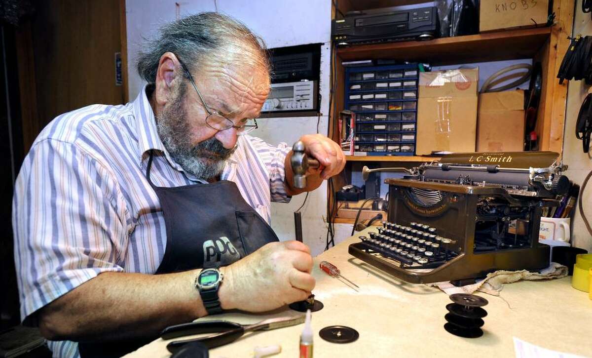 David Morrill, who runs American Typewriter and Amtype Repair Service in New Milford, works on restoring a 1936 LC Smith Secretarial office manual typewriter.