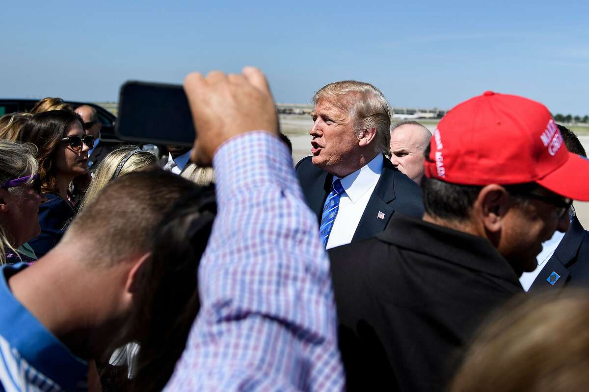 US President Donald Trump greets people as he arrives at Kansas City International Airport July 24, 2018 in Kansas City, Missouri. Trump will give remarks at the Veterans of Foreign Wars of the United States National Convention in Kansas City. / AFP PHOTO / Brendan SmialowskiBRENDAN SMIALOWSKI/AFP/Getty Images