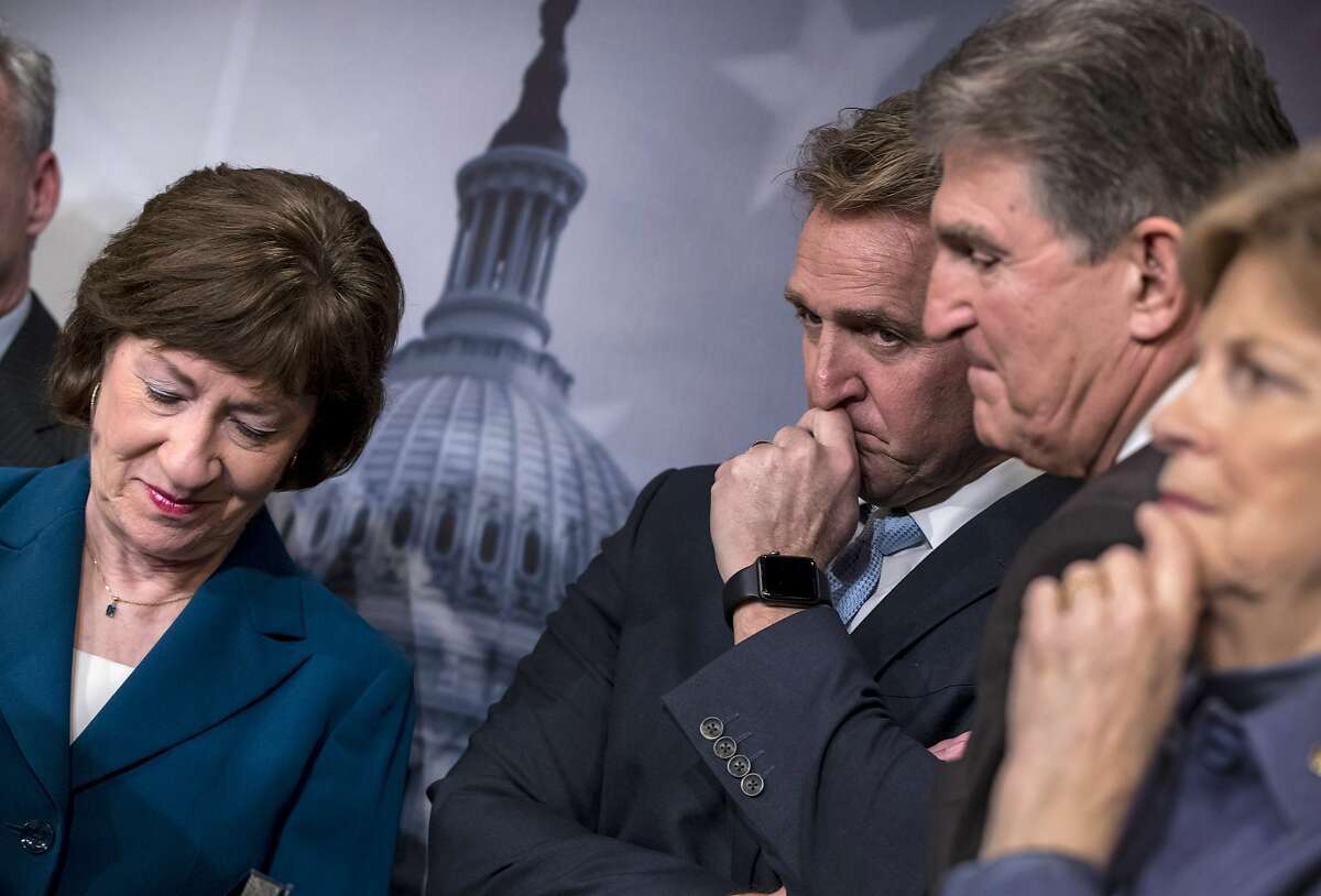 From left, Sen. Susan Collins, R-Maine, Sen. Jeff Flake, R-Ariz., Sen. Joe Manchin, D-W.Va., and Sen. Jeanne Shaheen, D-N.H., finish a news conference on the bipartisan immigration deal they reached during a news conference at the Capitol in Washington, Thursday, Feb. 15, 2018. The Trump administration is already denouncing their deal in the Senate, saying it will "create a mass amnesty for over 10 million illegal aliens, including criminals." " (AP Photo/J. Scott Applewhite)