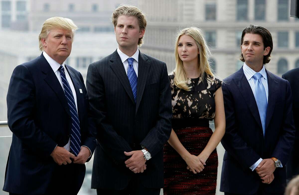 Real estate developer Donald Trump, left, waits to be announced with his children, from left, Eric, Ivanka, and Donald Jr., during topping off festivities for the 92-story Trump International Hotel and Tower in Chicago, Wednesday, Sept. 24, 2008. Trump, commenting on the economic bailout plan at the news conference said the $700 billion plan is probably necessary because it looks like the economy is "rushing into one big depression." (AP Photo/Charles Rex Arbogast)