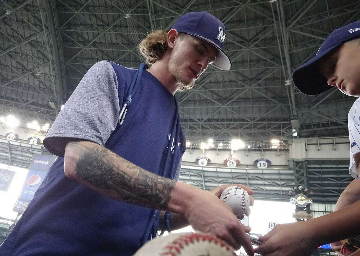 Milwaukee Brewers relief pitcher Josh Hader signs autographs before a baseball game against the Los Angeles Dodgers Sunday, July 22, 2018, in Milwaukee. (AP Photo/Morry Gash)