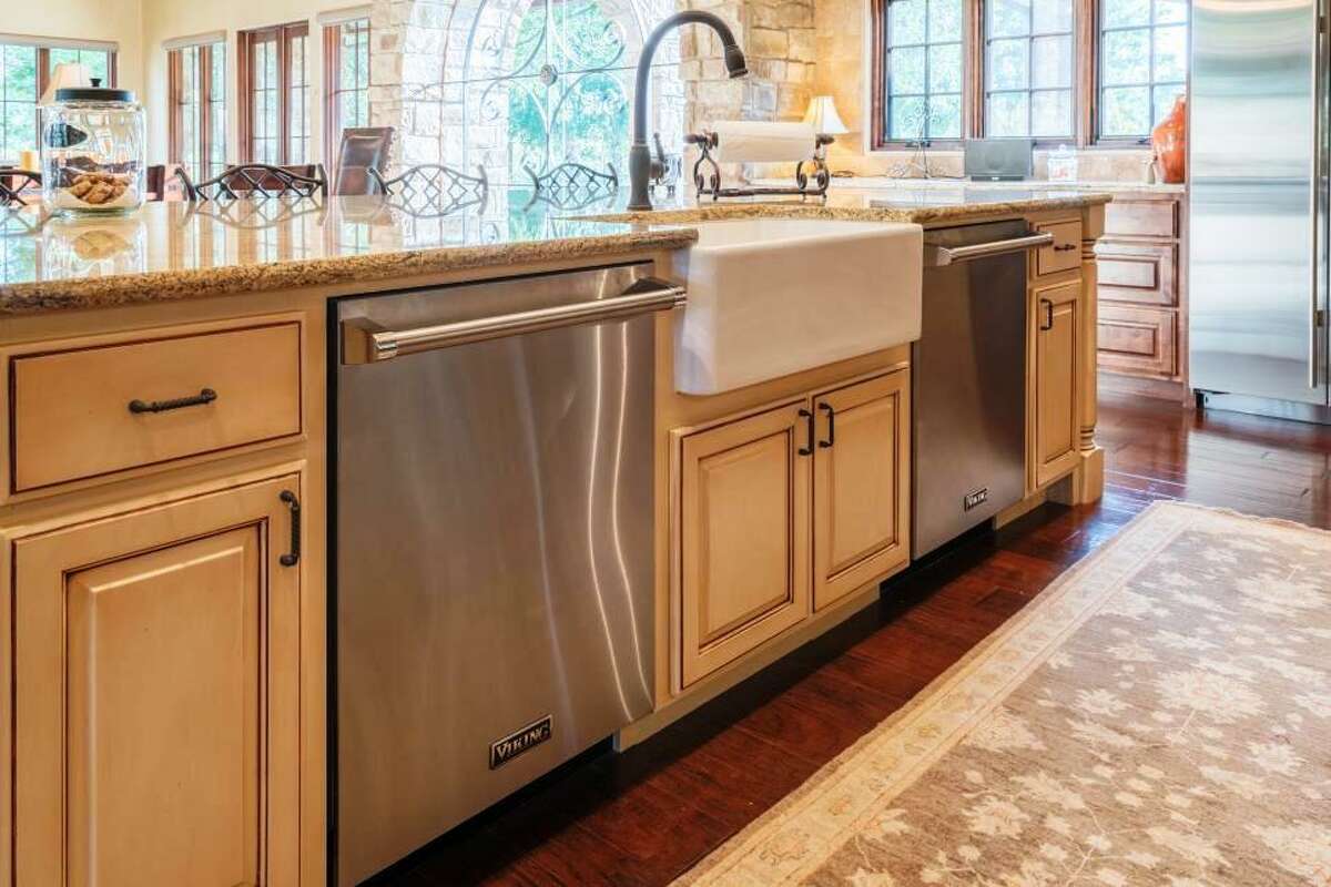 For homeowners who love to entertain, dual dishwashers -- here efficiently set into the cabinets on either side of the sink -- are very desirable features. There's enough room to throw in all the pots, pans, dishes and glassware they?’ve used and get it all cleaned at once.
