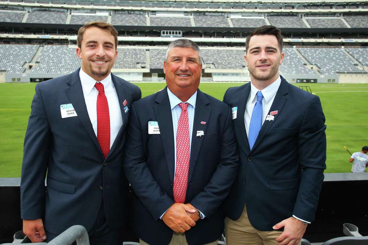 Sacred Heart quarterback Kevin Duke, coach Mark Nofri and wide receiver Andrew O'Neill pose for a photo during NEC media day at MetLife Stadium in East Rutherford, N.J. on Tuesday.