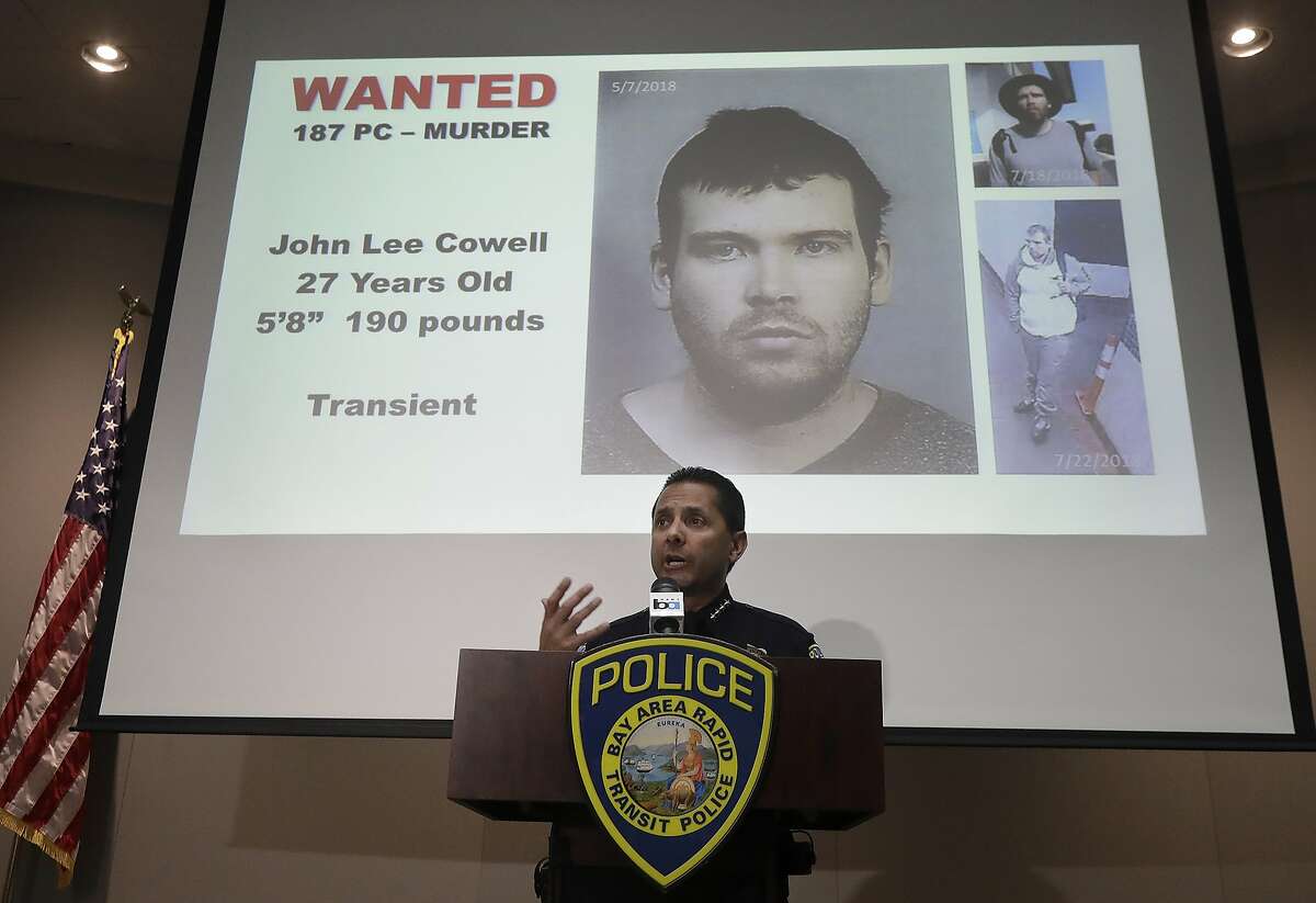 Bay Area Rapid Transit Police Chief Carlos Rojas speaks at a news conference in front of images of John Lee Cowell, a suspect wanted in the stabbings of two women at a BART station, in Oakland, Calif., Monday, July 23, 2018. A man fatally stabbed an 18-year-old woman in the neck and wounded her sister as they exited a train at a Northern California subway station in what officials said Monday appeared to be a random attack. (AP Photo/Jeff Chiu)