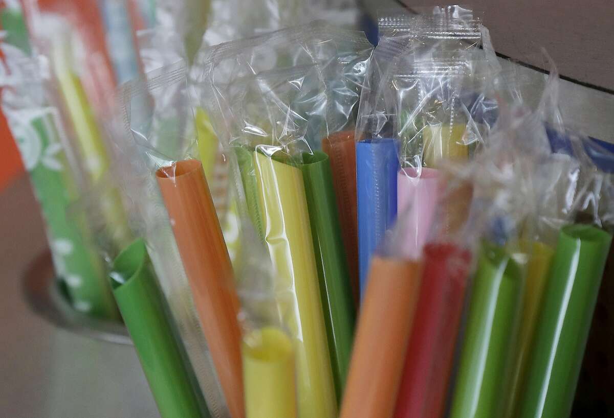 This July 17, 2018 photo shows wrapped plastic straws at a bubble tea cafe in San Francisco. Eco-conscious San Francisco joins the city of Seattle in banning plastic straws, along with tiny coffee stirrers and cup pluggers, as part of an effort to reduce plastic waste. It also makes single-use food and drink side items available upon request and phases out the use of fluorinated wrappers and to-go containers. (AP Photo/Jeff Chiu)