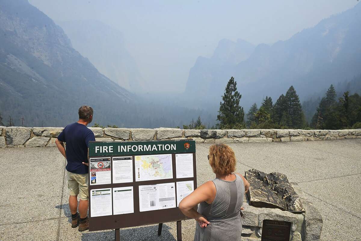 Smoke from the Ferguson Fire fills Yosemite Valley as seen from Tunnel View Tuesday, July 24, 2018, in Yosemite National Park, Calif. A Yosemite National Park official says at least a thousand campground and hotel reservations will be canceled after authorities decided to close Yosemite Valley to keep a growing forest fire at bay. Spokesman Scott Gediman says the valley, the heart of the visitor experience at the park, along with a windy, mountainous, 20-mile (32-kilometer) stretch of State Route 41 that is part of Yosemite will close beginning Wednesday at noon. (Eric Paul Zamora/The Fresno Bee via AP)