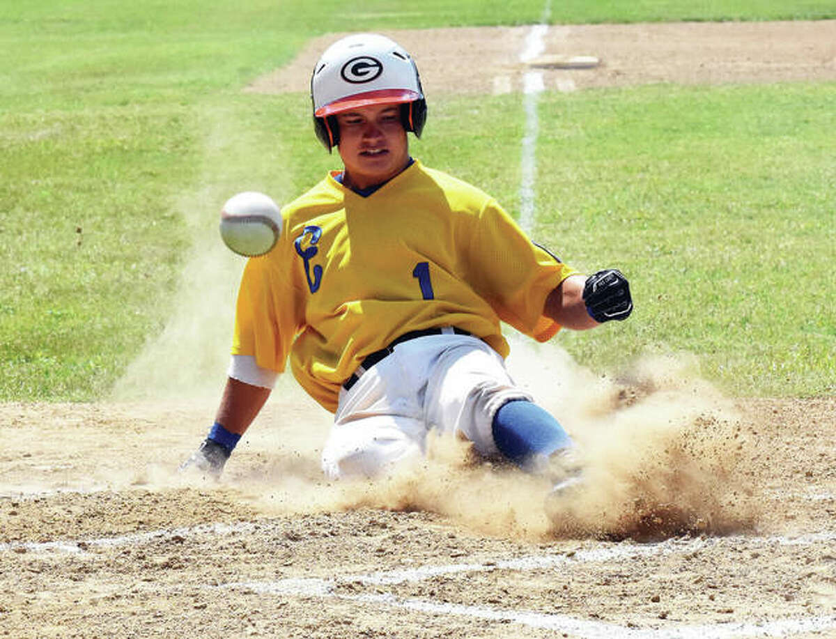 Edwardsville Post 199’s Tate Wargo slides safely across home plate with a run as the throw gets away from the catcher during play at the Senior Legion State Tournament earlier this week at Aviston.
