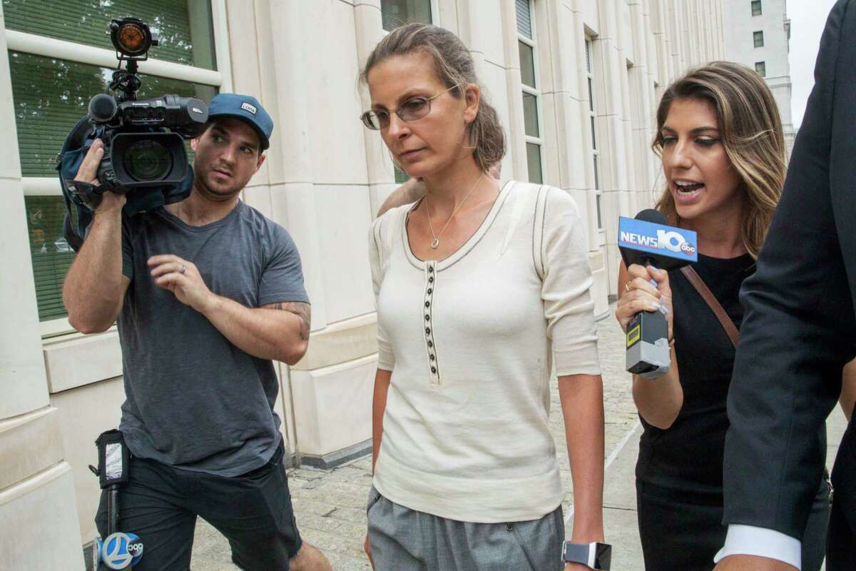 Clare Bronfman, center, arrives at federal court, Wednesday, July 25, 2018, in the Brooklyn borough of New York. Bronfman, an heiress to the Seagram's liquor fortune and three other people were arrested on Tuesday in connection with the investigation of a self-improvement organization accused of branding some of its female followers and forcing them into unwanted sex.