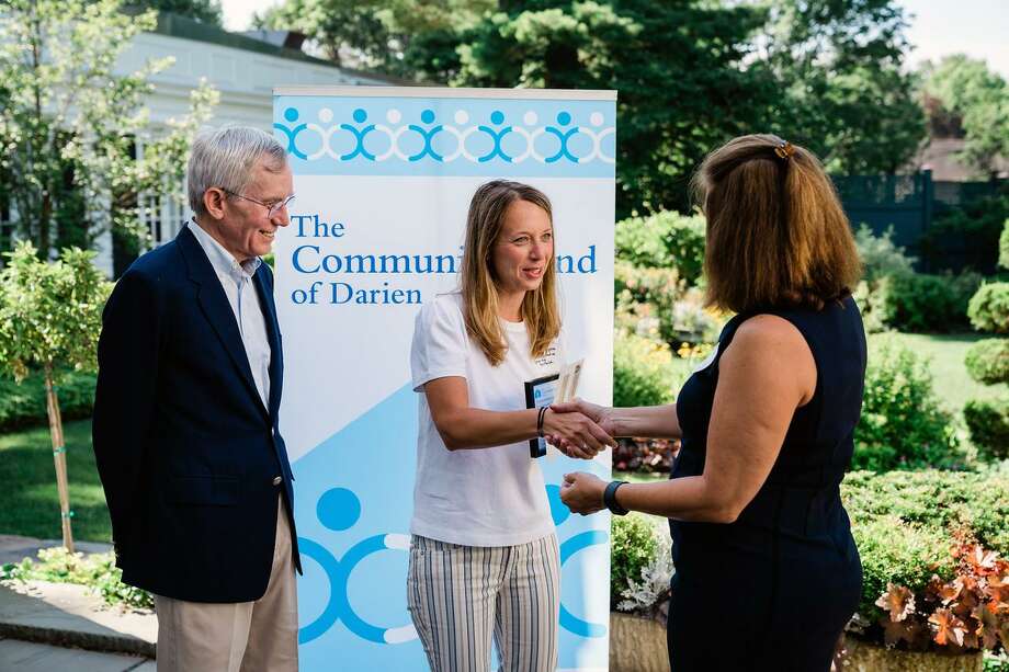   Community Fund Board Chair Frank Huck and Community Fund Development Director Laurie Orem hand over a check to Marissa Mangone, Director of Business Development for the Child Guidance Center of the County from Mid-Fairfield. Photo: Contribution Photo / Calderwood Digital 