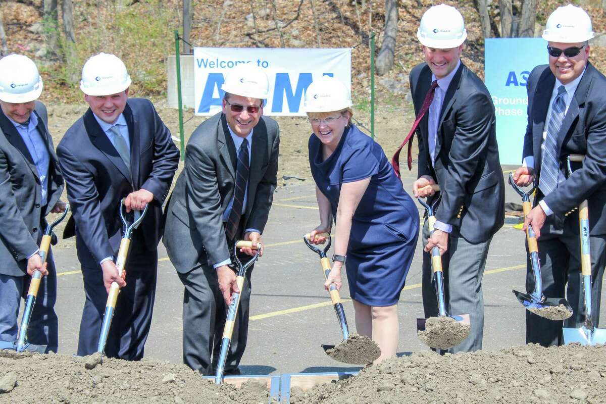 Employees and guests gather at the headquarters of ASML, along Route 7, in Wilton, Conn. on Thursday, May 3, 2018. The technology manufacturer announced in February 2018 it would create up to 524 additional jobs in the next few years at its headquarters.