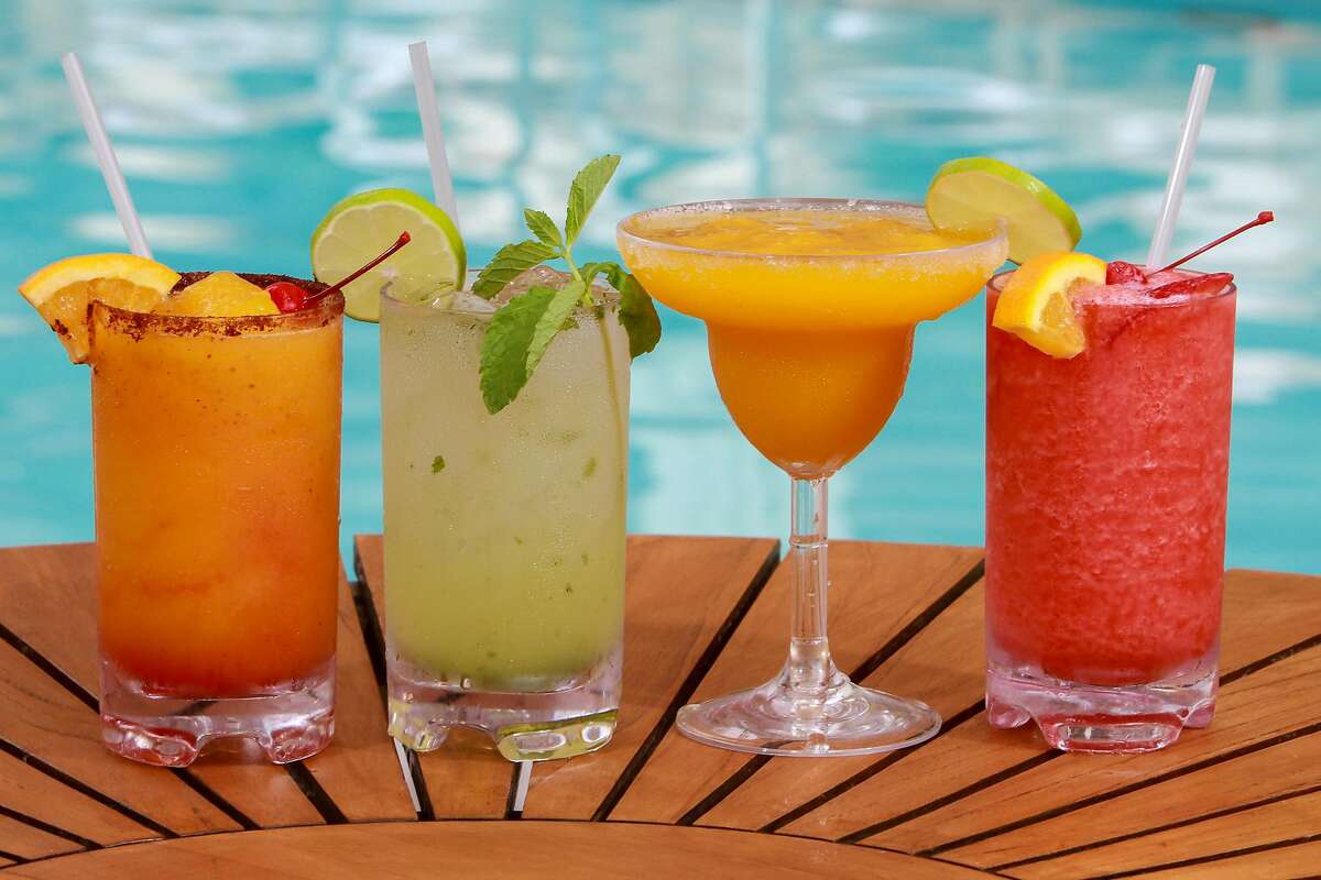 Starboard Sunset, from left, Mojito, Mango Margarita and Strawberry Daiquiri, on the pool deck at The Four Seasons Hotel. (For the Chronicle/Gary Fountain, May 31, 2016)
