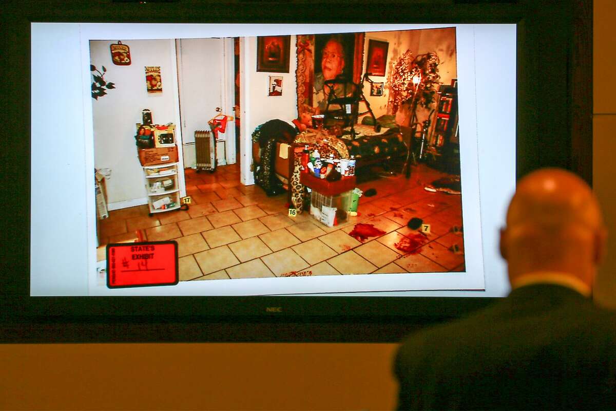 Prosecutor Scott Simpson introduces state's exhibit #14, a photo of the inside of Tandylyn Jackson's apartment showing blood stains in the lower right corner, in the opening of the capital murder trial of Luis Antonio Arroyo, in the 227th state District Court presided by Judge Kevin O'Connell on Monday, July 16, 2018. Arroyo is accused of killing Quickether Jackson, 36, and Rodney Spring, 47, on January 21, 2016. The state is seeking the death penalty in this case, the first time since 2015.