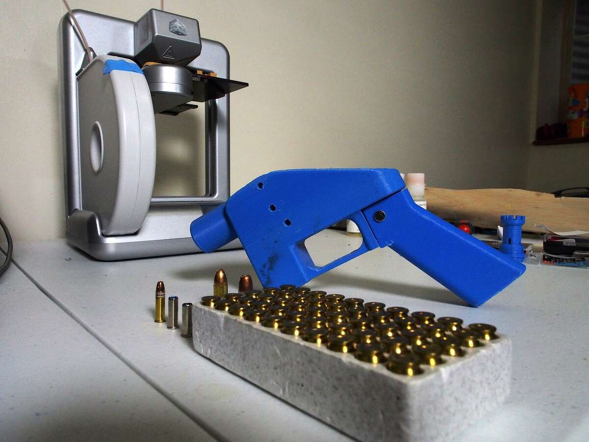 A Liberator pistol appears on July 11, 2013 next to the 3D printer on which its components were made. The single-shot handgun is the first firearm that can be made entirely with plastic components forged with a 3D printer and computer-aided design (CAD) files downloaded from the Internet.