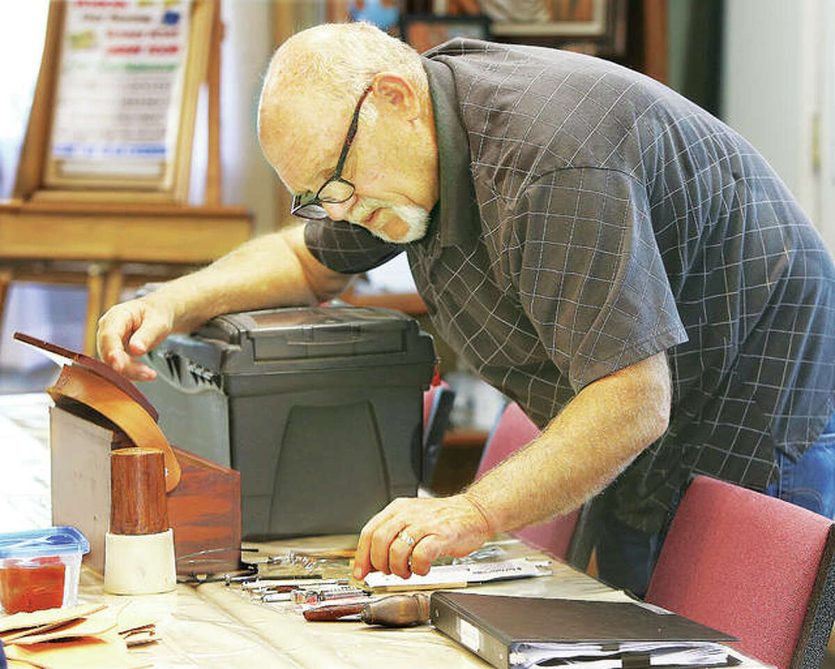 Leatherwork artist Terry Diveley prepares his tools before teaching a leather tooling and painting class this week in Wood River at Von Dell Gallery, 102 E. Ferguson Ave., where he leases a studio. He also teaches a leather tooling class at the gallery.