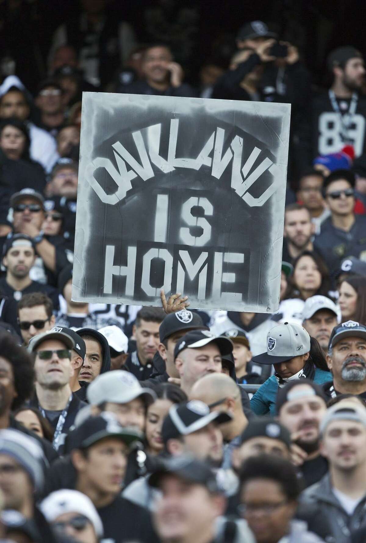 OAKLAND, CA - DECEMBER 4: Fans cheer on the Oakland Raiders against the Buffalo Bills on December 4, 2016 at Oakland-Alameda County Coliseum in Oakland, California. The Raiders won 38-24. (Photo by Brian Bahr/Getty Images) *** Local Caption ***