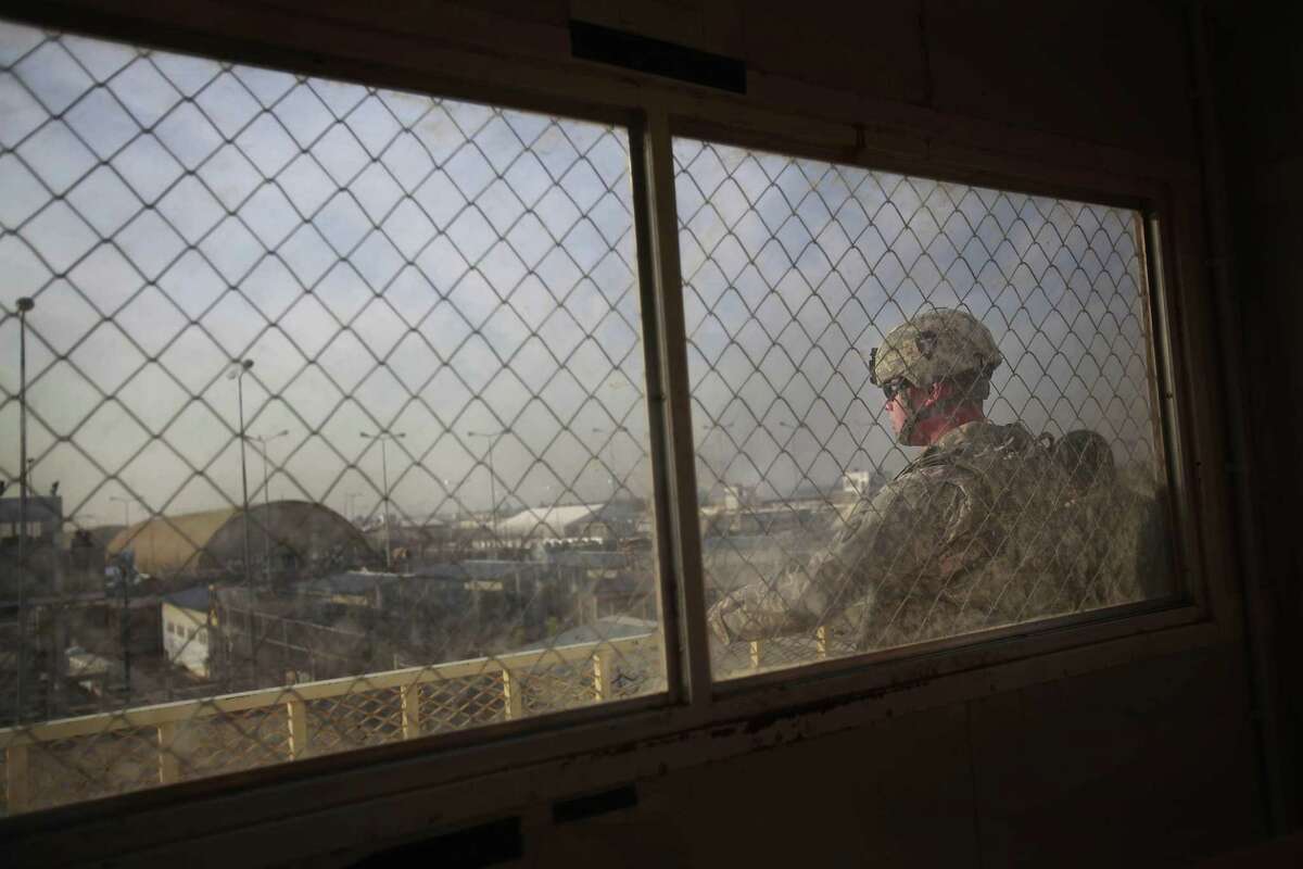 Pfc. Justin Haynes, 25, of Houston, says he gets headache while working in a watchtower at the detainee internment facility at Camp Taji where other soldiers also complain of headaches, coughs, sore throats, irritated eyes and skin rashes. Hundreds of Texas National Guard soldiers live and work in Taji, where they have been assigned to guard more than 3,000 detainees in the internment facility. The burn pit is located a few hundred yards from the outer walls of the facility. Photos taken on Jan. 17, 2010 in Iraq. Mayra Beltran / Houston Chronicle