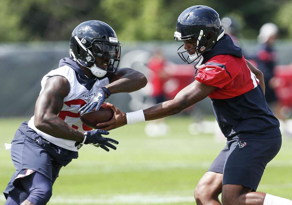 Houston Texans quarterback Deshaun Watson (4) hands the ball off to running back Lamar Miller (26) during training camp at The Greenbrier Sports Performance Center on Thursday.