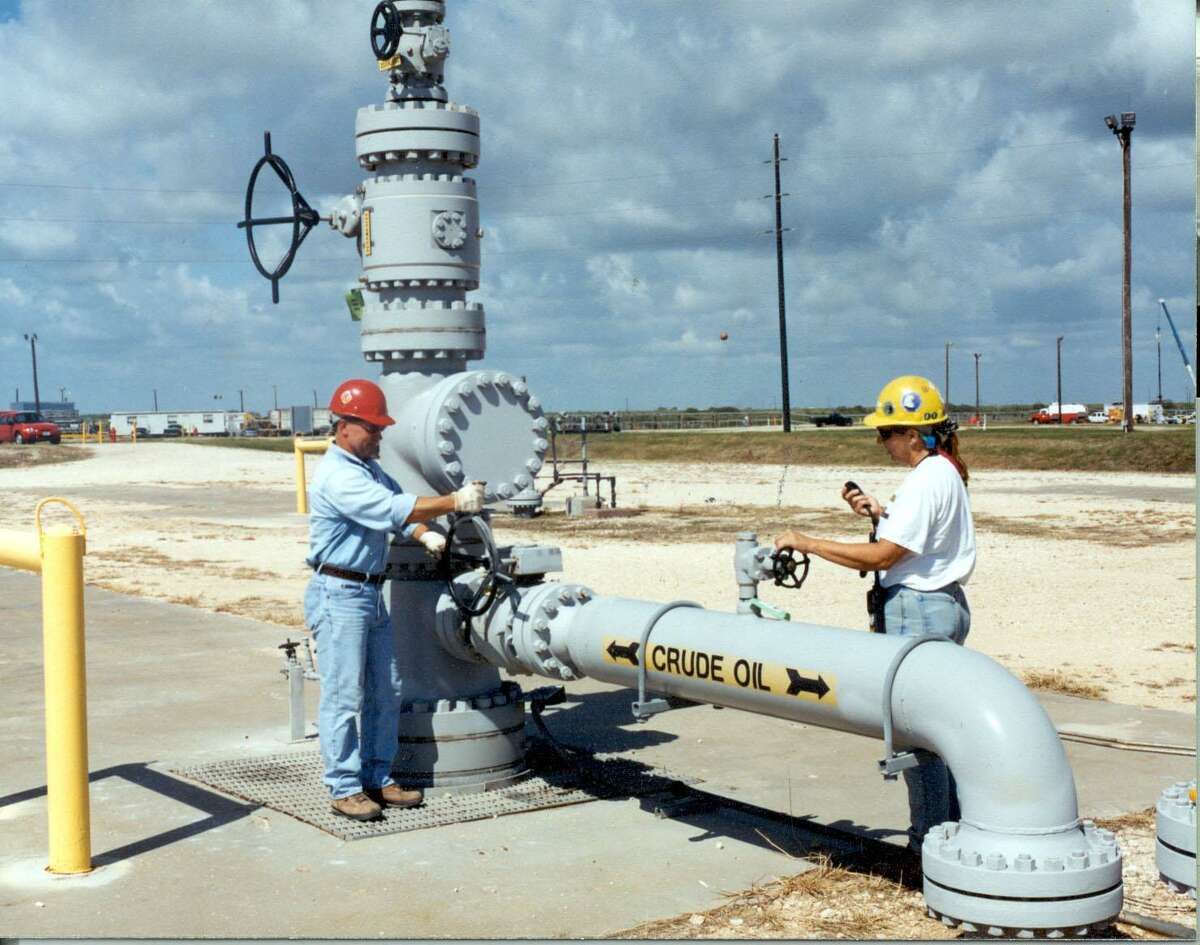 Workers test a wellhead valve at the U.S. Strategic Petroleum Reserve's Bryan Mound facility in Texas in this undated Department of Energy photo. 