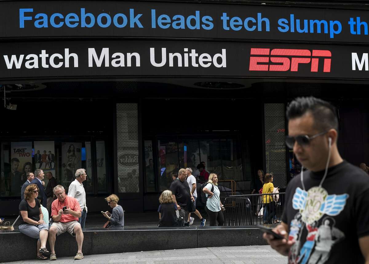 NEW YORK, NY - JULY 26: A news ticker in Times Square displays a headline about Facebook's stock decline, July 26, 2018 in New York City. On Thursday, Facebook posted the largest one-day loss in market value by any public company in U.S. stock market history after they released a disappointing second-quarter earnings report. (Photo by Drew Angerer/Getty Images)