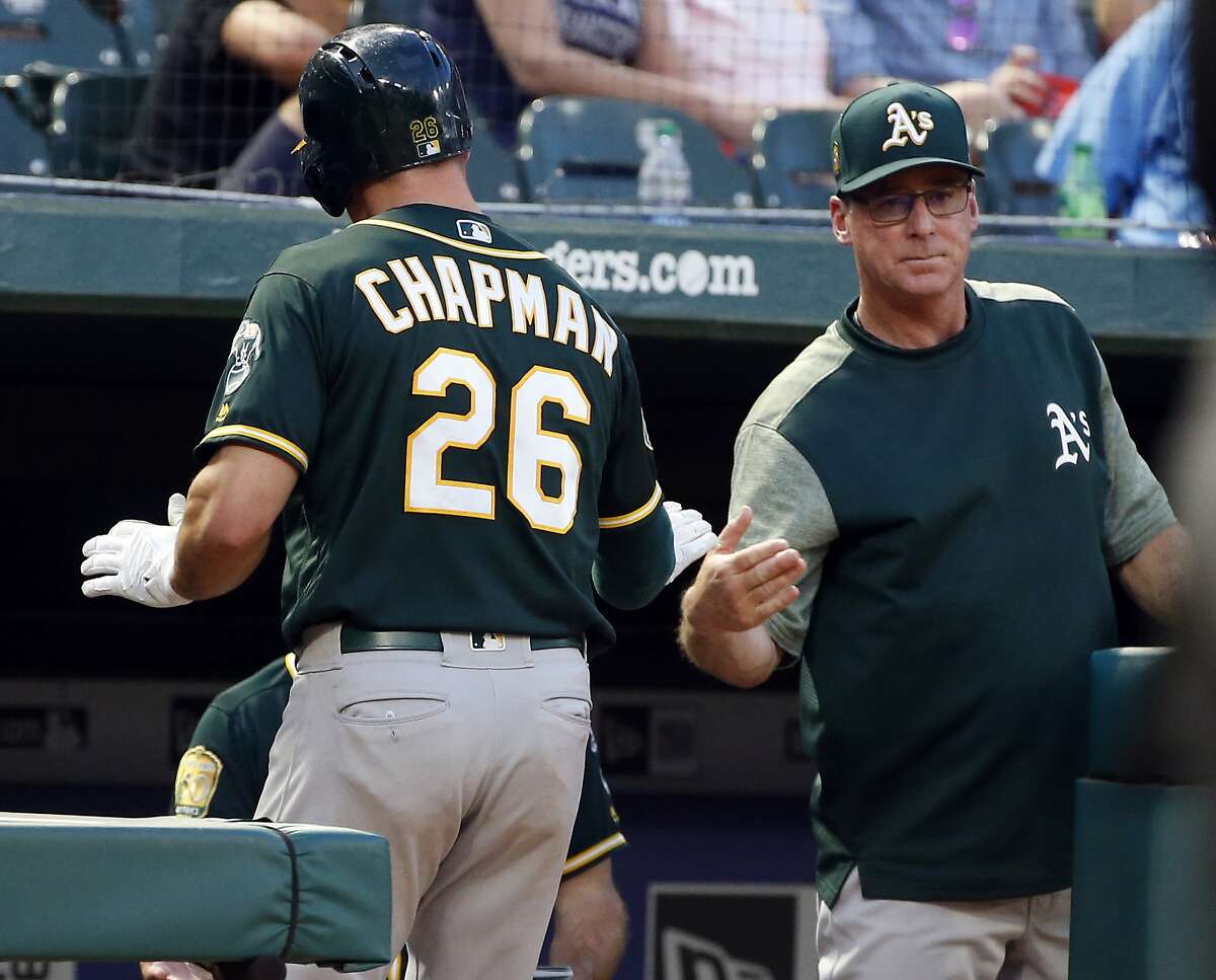 Oakland Athletics' Matt Chapman (26) is congratulated by manager Bob Melvin (6) after Chapman scored against the Texas Rangers during the fourth inning of a baseball game Thursday, July 26, 2018, in Arlington, Texas. (AP Photo/Michael Ainsworth)