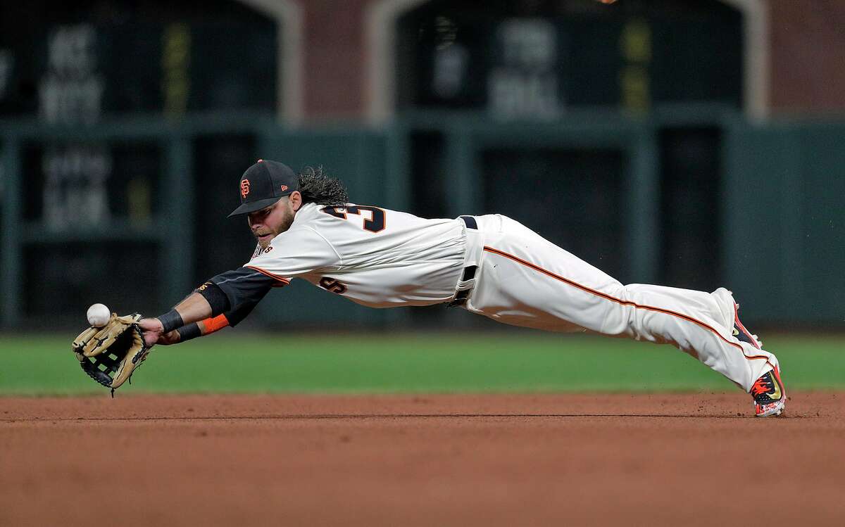 Brandon Crawford (35) can't reach a ball hit by Travis Shaw (21) to left allowing Christian Yelich (22) to advance to third in the eighth inning as the San Francisco Giants played the Milwaukee Brewers at AT&T Park in San Francisco, Calif., on Thursday, July 26, 2018.
