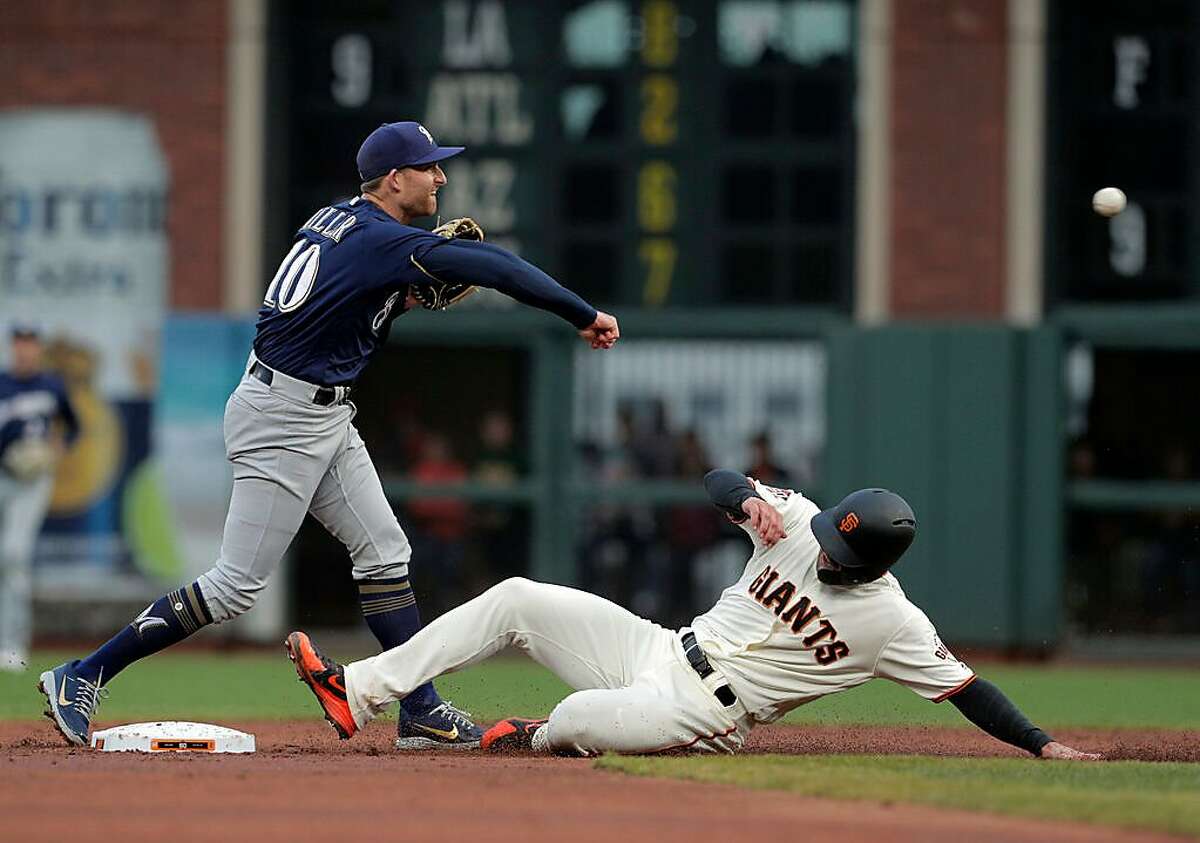 Brad Miller (10) throws to first to complete a double play as Chase d'Arnaud (2) approaches on a ball hit by Austin Slater (53) in the first inning as the San Francisco Giants played the Milwaukee Brewers at AT&T Park in San Francisco, Calif., on Thursday, July 26, 2018.