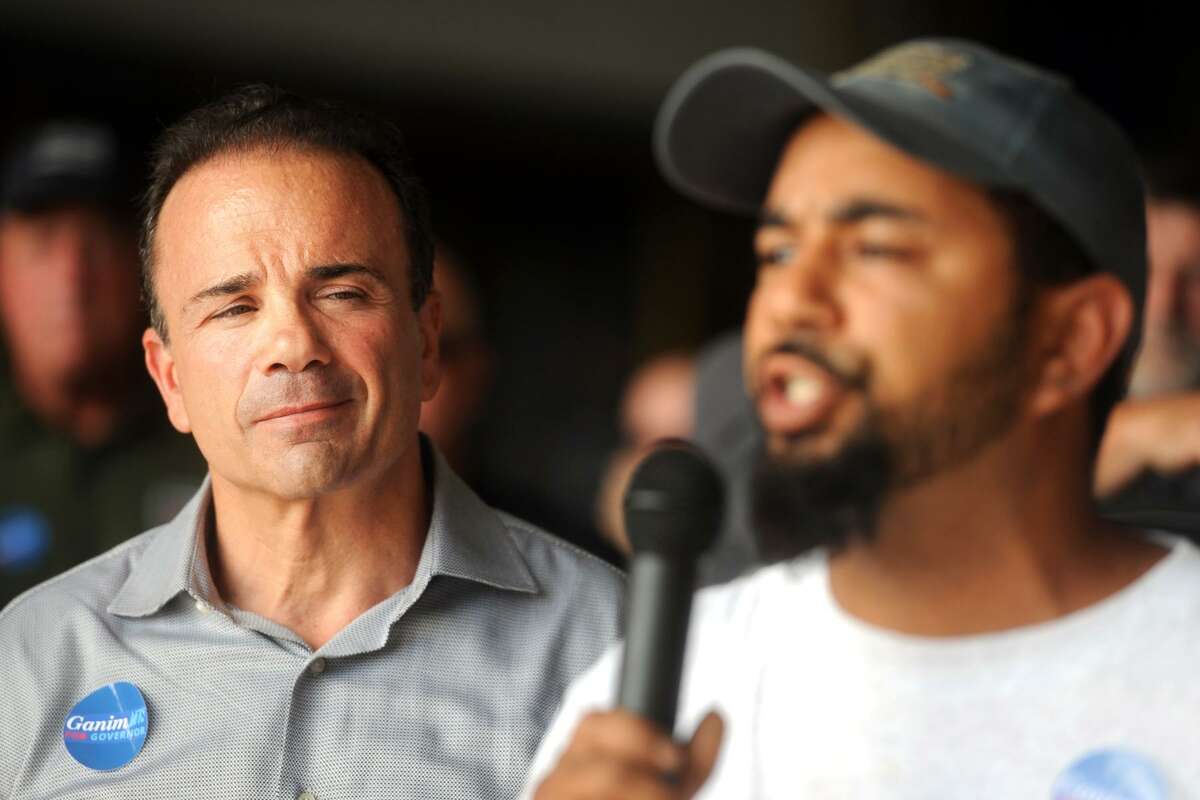 Bridgeport Mayor Joe Ganim looks on as Luis Soto, a construction worker and union member from Bridgeport, speaks during an event at the former Derecktor Shipyards property in Bridgeport, Conn. July 24, 2018. Local labor union members gathered to express their support for Ganim, who is a democratic candidate for Governor.