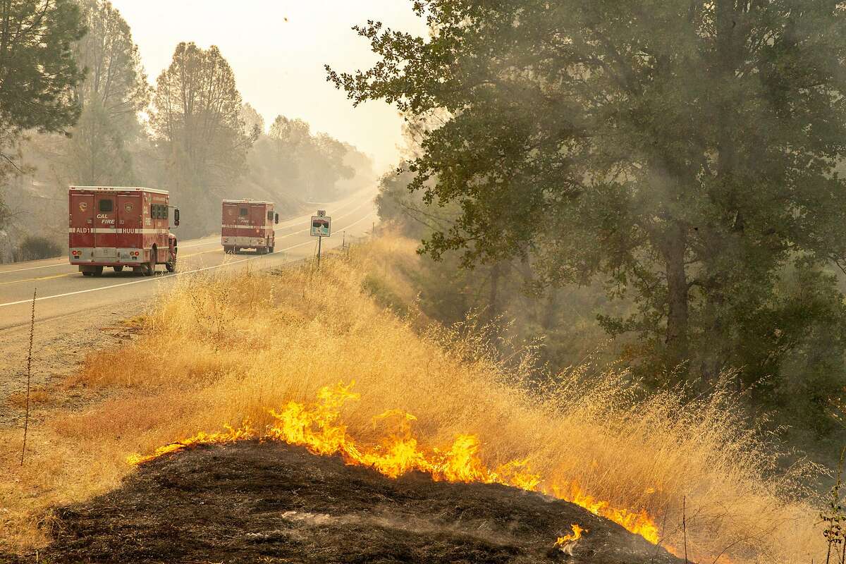 Cal Fire vehicles head towards Redding from Shasta along Highway 299 on July 27, 2018.
