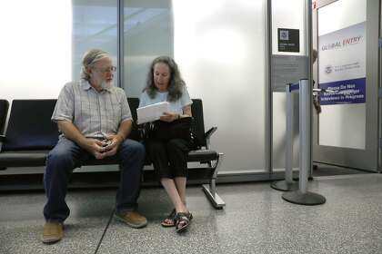 Gary Bauman (left) and his wife Sally Bauman (right) wait for their Global Entry interview appointments at SFO in 2018. Global Entry lets “trusted travelers” take a shortcut through immigration when they return from a foreign trip to major U.S. airports, including SFO,