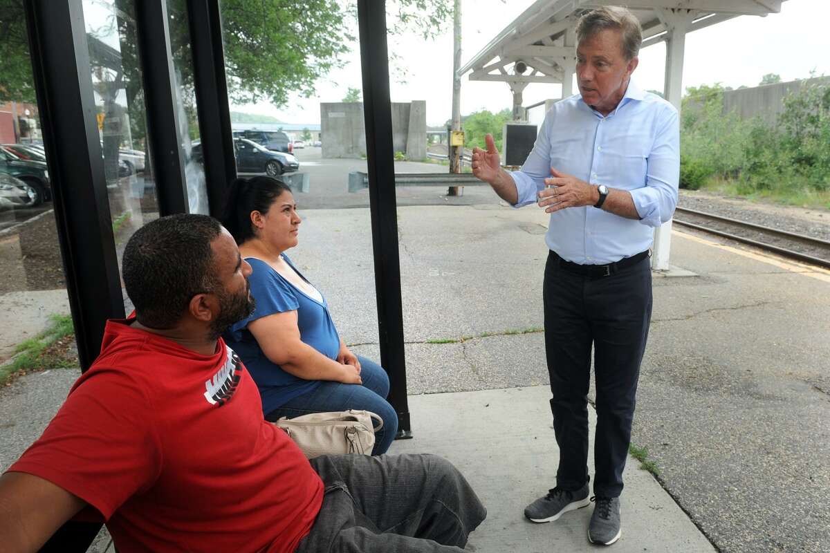 Democratic gubernatorial candidate Ned Lamont speaks to Alexander Capeles and Ana Houston, both of Ansonia, as they wait to catch the Waterbury line Metro-North train to Waterbury at the Ansonia train station, in Ansonia, Conn. July 23, 2018.