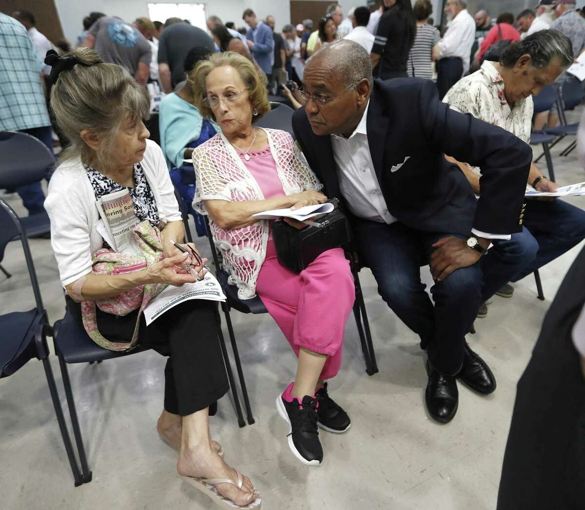 Commissioner Rodney Ellis of Harris County Precinct One speaks to Argelia Pinon, center, and Margret Toman, left, as Harris County held one in a series of public meetings on the $2.5 billion flood bond proposal at the El Franco Lee Community Center, Tuesday, July 17, 2018, in Houston. ( Karen Warren / Houston Chronicle )