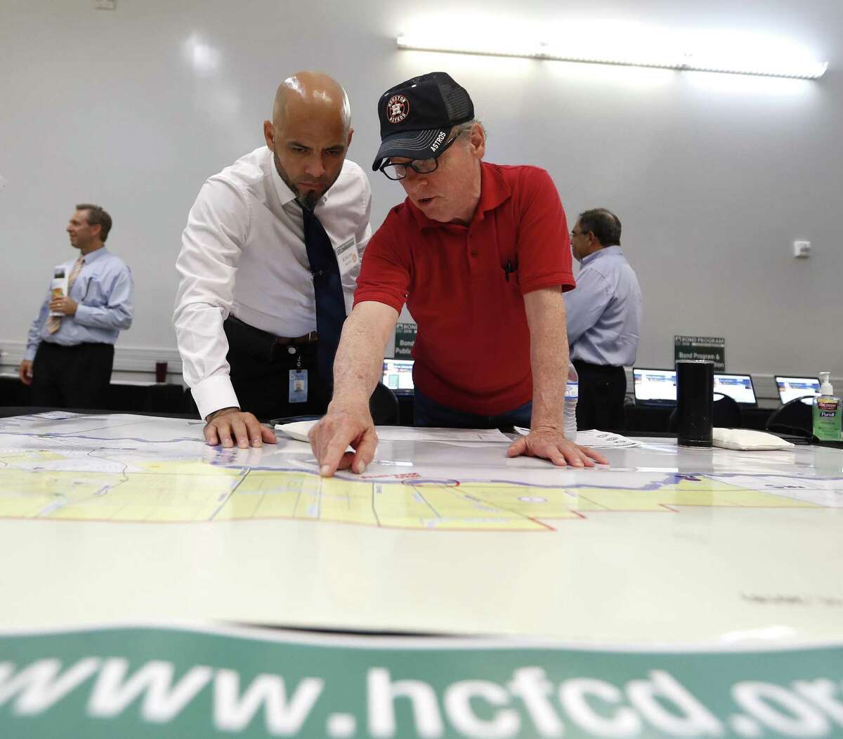 Armando Sanchez, left, helps Don Corolla as they point to a spot on a map as Harris County held one in a series of public meetings on the $2.5 billion flood bond proposal at the El Franco Lee Community Center, Tuesday, July 17, 2018, in Houston. ( Karen Warren / Houston Chronicle )