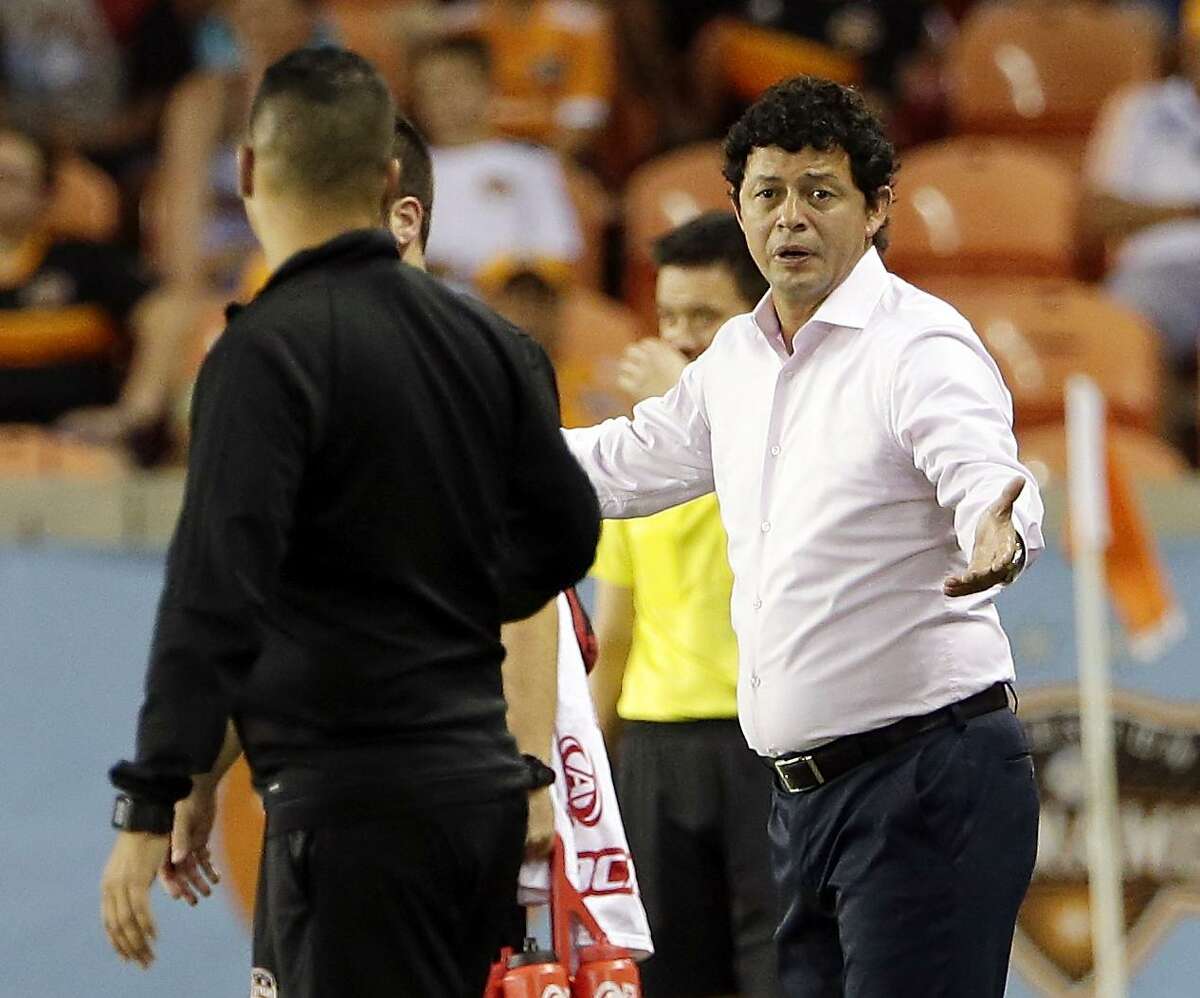 Dynamo coach Wilmer Cabrera questions officials after a goal by the Union on July 25. Cabrera is concerned about the number of matches his club has finished down a man because of ejections.