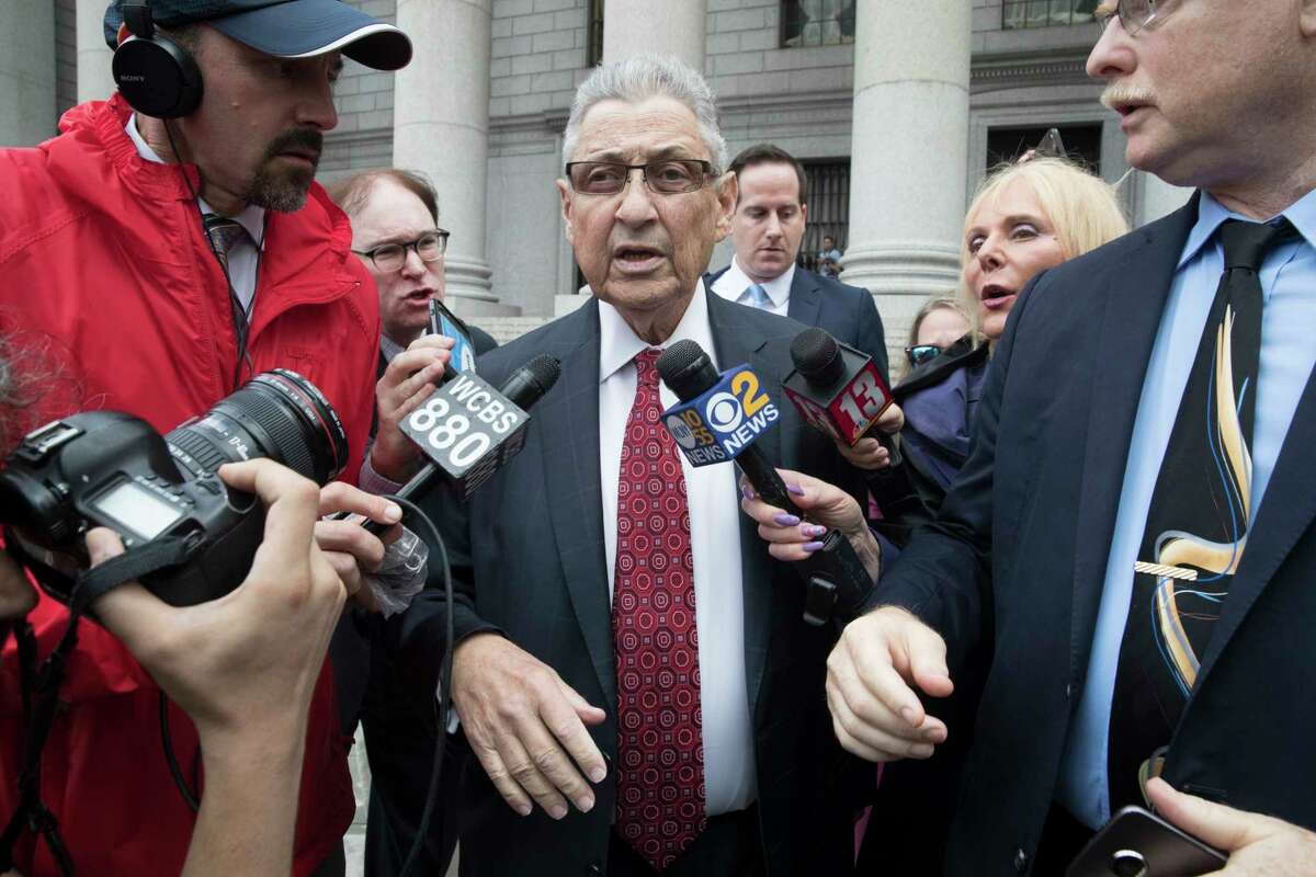 Former New York Assembly Speaker Sheldon Silver, center, is surrounded by reporters as he leaves federal court in New York after his sentencing, Friday, July 27, 2018. Silver, a former New York Assembly speaker who brokered legislative deals for two decades before criminal charges abruptly ended his career, was sentenced Friday to seven years in prison by a judge who said political corruption in the state "has to stop." (AP Photo/Mary Altaffer)