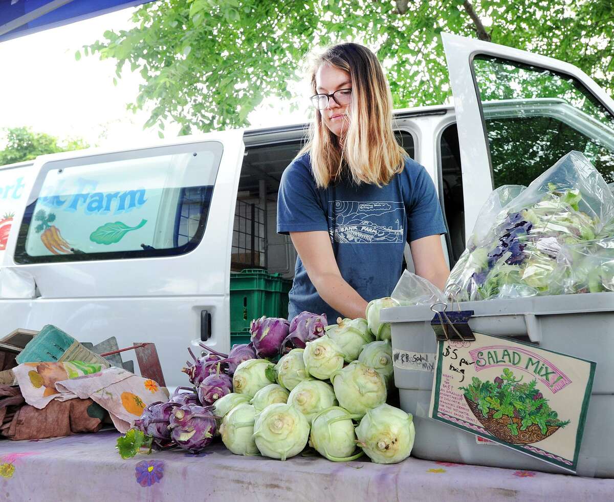 Kate Getz of Riverbank Farm in Roxbury, stacks kohlrabi at the Old Greenwich Farmers Market at the Living Hope Church in Old Greenwich on June 6. "It's an alien-looking vegetable in the broccoli family that's a real conversation starter," said Getz. The market is open every Wednesday at the church from 2:30 to 6 p.m