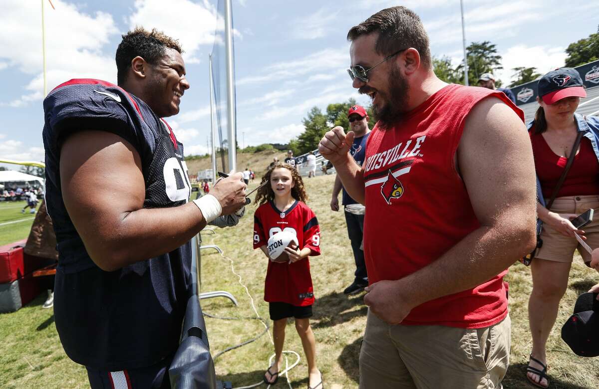 Houston Texans defensive end Christian Covington (95) signs autographs following practice during training camp at the Greenbrier Sports Performance Center on Saturday, July 28, 2018, in White Sulphur Springs, W.Va.