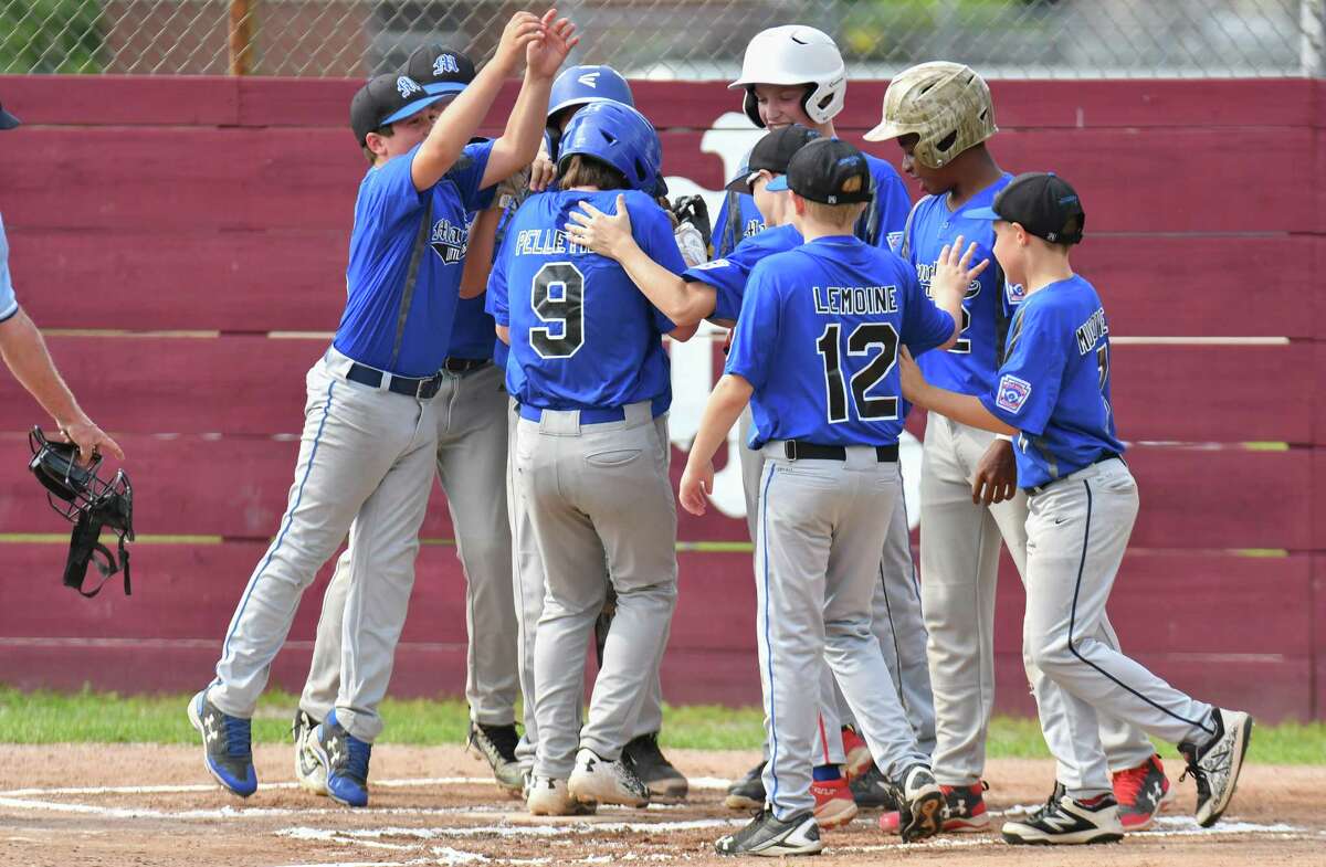 Alex Pellitier (9) of Manchester is congratulated by his teammates after hitting a two run homer during a State Little League playoff game against Wallingford on Saturday July 28, 2018, in Niantic, Connecticut.