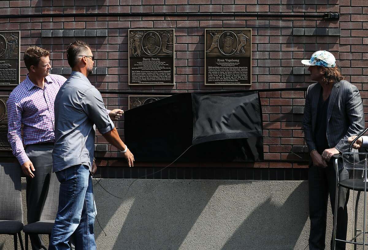 (Left to right) Former San Francisco Giants baseball players Matt Cain, Ryan Vogelson, and Brian Wilson pull a rope to reveal their plagues during the Wall of Fame ceremony at AT&T Park in San Francisco, Cali. on Saturday, July 28, 2018.