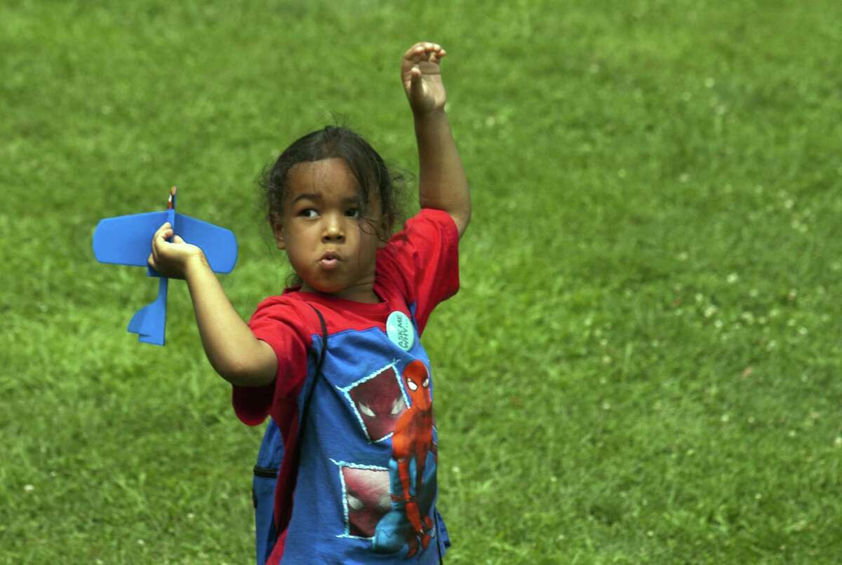 Bryan Colon, 5, of Bridgeport, plays with a toy airplane during Family Fitness Day on Paradise Green in Stratford, Conn., on Saturday, July 28, 2018. The event, held by Get Healthy CT, coincides with National Dance Day and encourages area residents of all ages to be physically active and eat healthy foods.