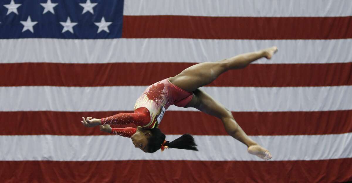 Olympic champion Simone Biles competes on the balance beam during the U.S. Classic gymnastics event Saturday, July 28, 2018, in Columbus, Ohio. The U.S. Classic is Biles' first competition since the 2016 Games. (AP Photo/Jay LaPrete)